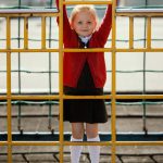 Girl on climbing frame, St Geraldine's Primary, Lossiemouth