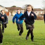 Pupils running on grass, Maurice wood Primary School, Penicuik