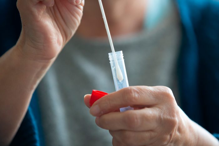 Woman taking COVID-19 swab