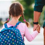 Dad taking little girl to school