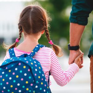 Dad taking little girl to school