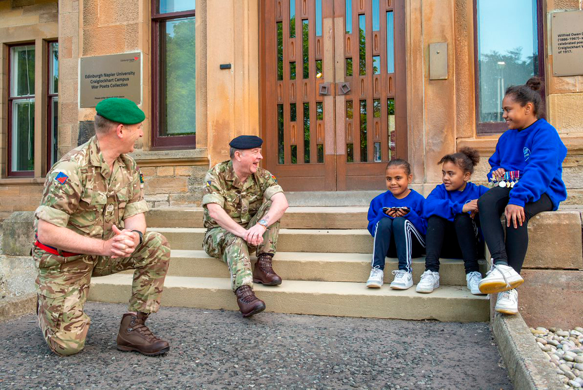 Personnel Recovery Officer Neil Davies and Officer Commanding Del Hamilton at Scotland and Northern Ireland Personnel Recovery Centre, with Samantha, Bella & Alice Kedrayate