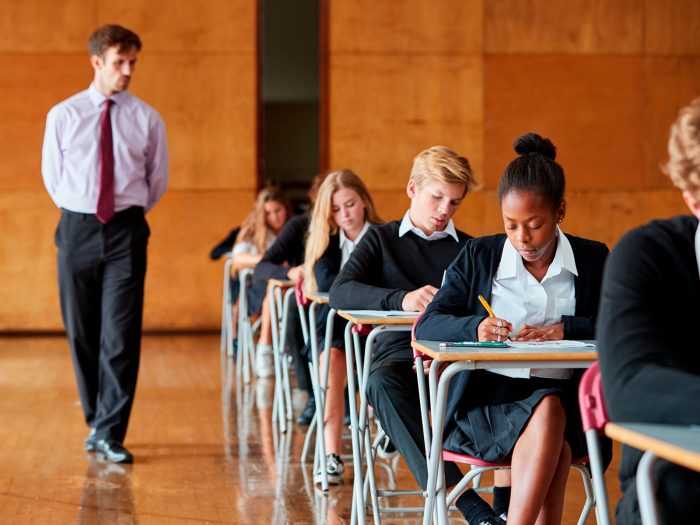 Students sitting in a traditional exam hall