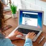 Woman navigating Firm Base website on a laptop