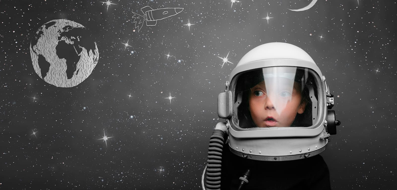 Child looking surprised in a retro styled space helmet