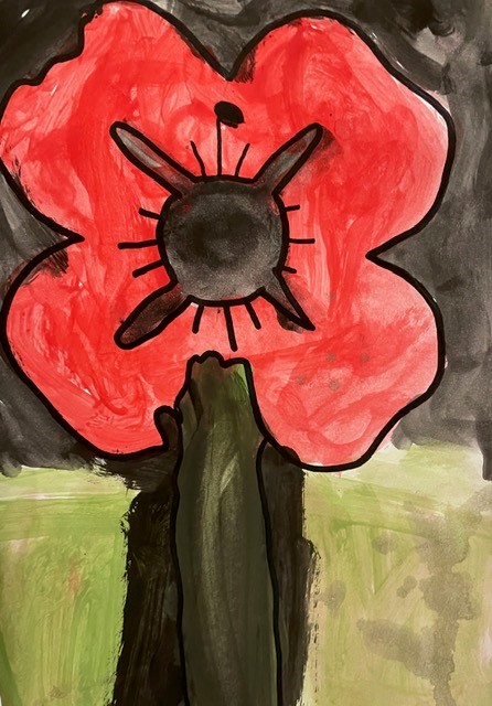 Close up of a child's watercolour poppy on a black background