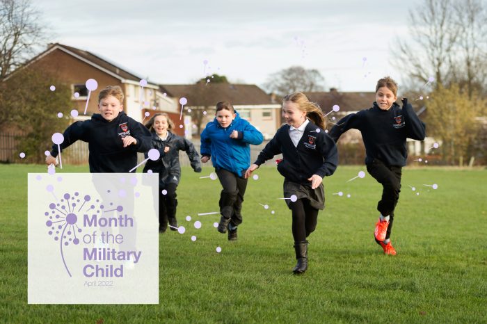 Month of the Military Child logo superimposed over the bottom left corner of an image of happy children running across a grassy field