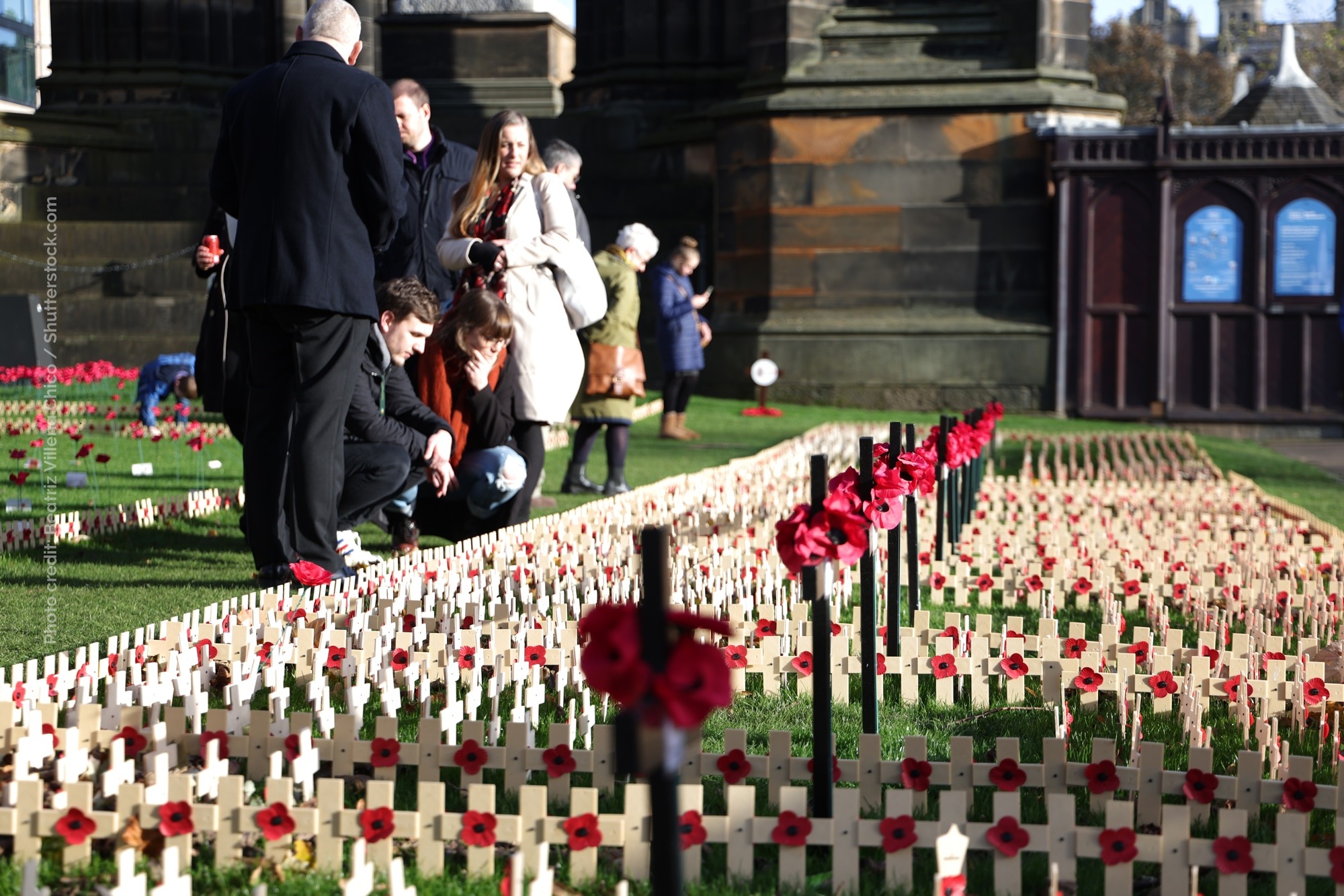A group pay their respects in the garden of remembrance at Princes St Gardens in Edinburgh.