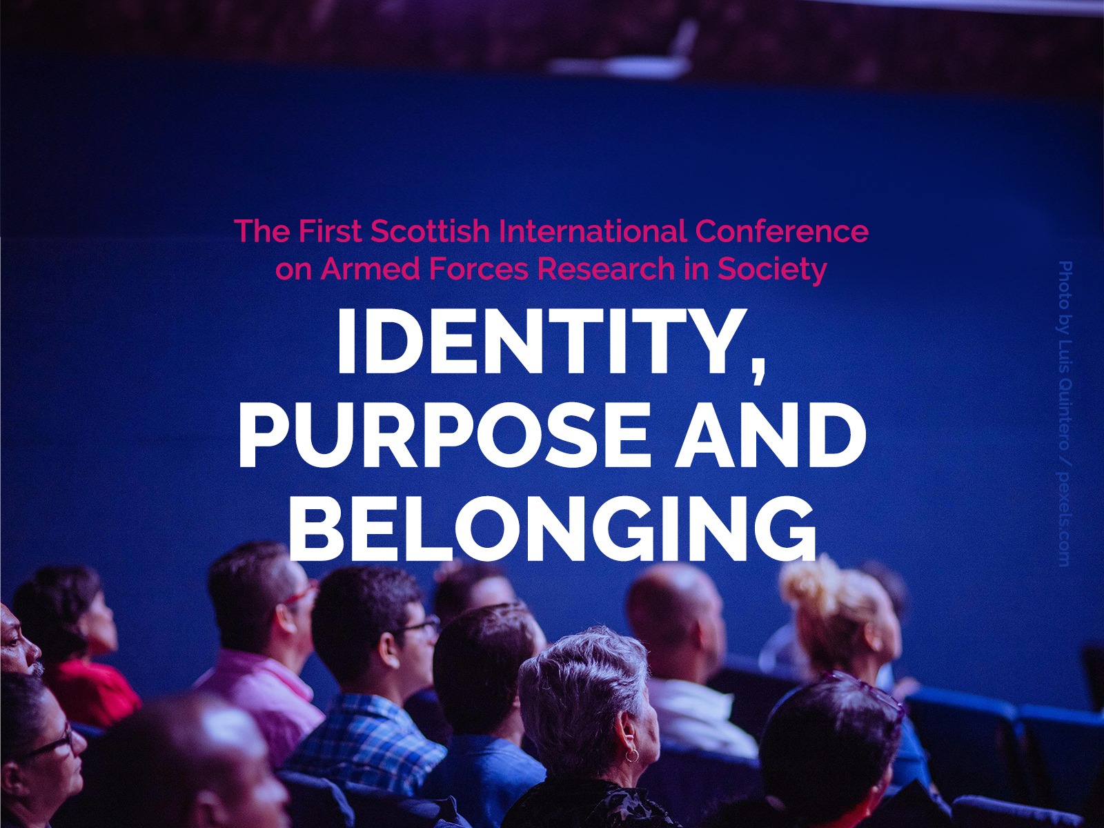 The words 'Identity, Prupose and belonging' float above an auditorium crowd all looking to the stage.