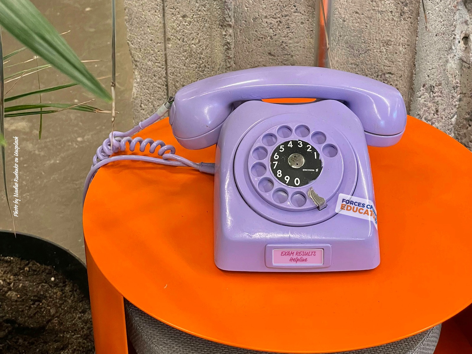 An old style rotary telephone with a label stating 'exam results helpline' on the front.