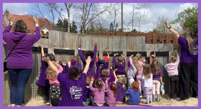 Educators and children from Midlothian Council's Scots Corner Early Learning & Childcare Centre show their support for purple up day.