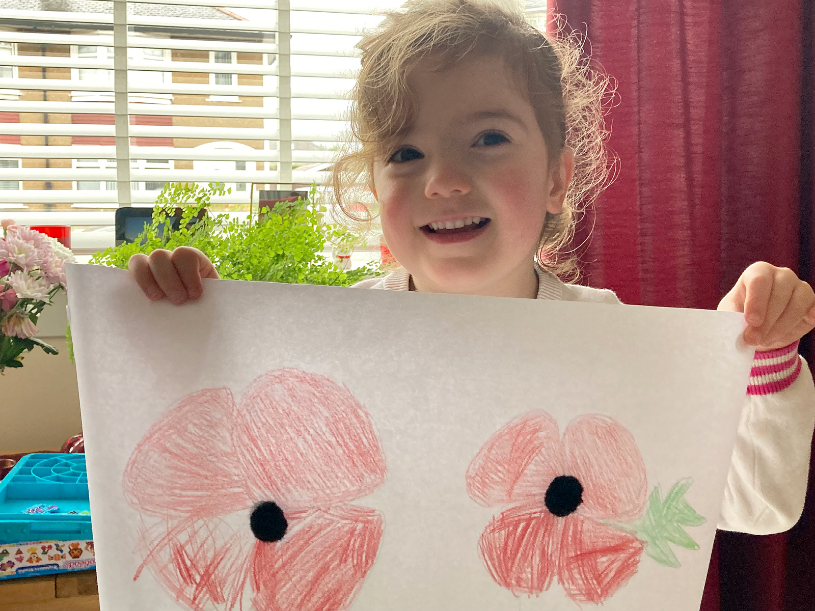 Calla, Age 4, with her pencil drawing of two poppies