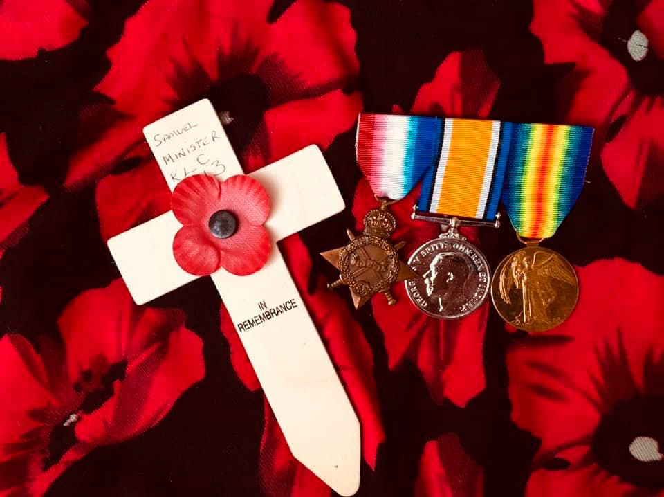 Grandad's medals superimposed on a poppy patterned background